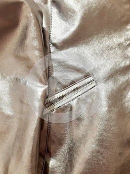 Metallic silver detail with zipper. Background design, photography. Textile, fabric template, modern new