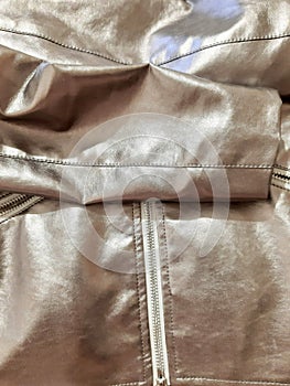 Metallic silver fragment of fashion clothes, zipper. Background design, photography. Textile, fabric template, modern new