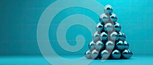 Metallic spheres in a pyramid shape on a turquoise background