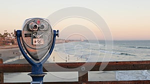 Metallic stationary observation tower viewer binoculars California pier USA. Coin operated telescope