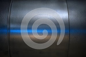 Metallic surface with blue glowing reflection, subtle curved light, right zone blank