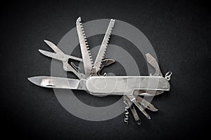 Metallic swiss knife isolated on black