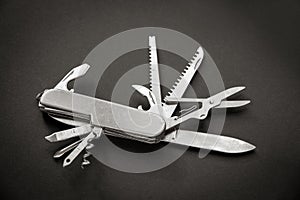 Metallic swiss knife isolated on black