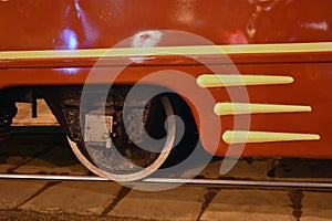 A metallic wheel on rail. Red tramway detail