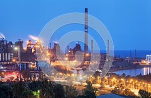 Metallurgical plant at night. Steel factory with smokestacks