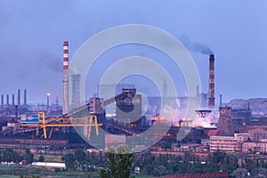 Metallurgical plant at night. Steel factory with smokestacks