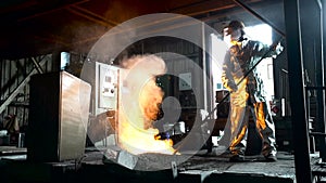 Metallurgist Job Worker In A Steel Plant Hot Molten Metal Pouring. Heavy Industry Worker Working Hard.