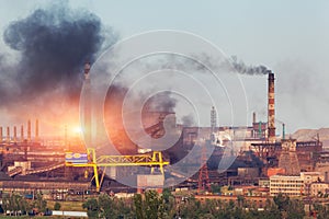 Metallurgy plant in Ukraine at sunset. Steel factory with smog
