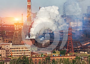 Metallurgy plant in Ukraine at sunset. Steel factory with smog