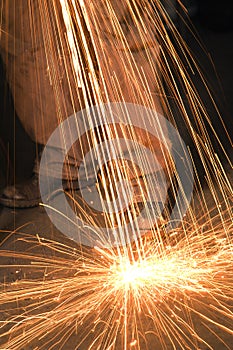 Metalsmith creating sparks.