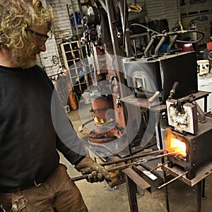 Metalsmith heating metal.