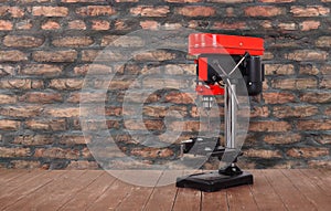 Metalwork tool - Red new drill press brick wall background