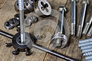 Metalwork tools on the workshop table. Threading dies and taps i