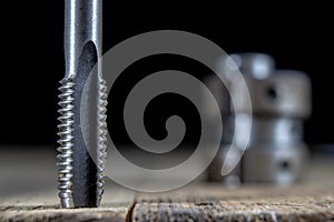 Metalwork tools on the workshop table. Threading dies and taps i