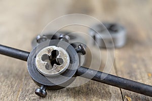 Metalwork tools on the workshop table. Threading dies and taps i