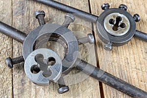 Metalwork tools on the workshop table. Threading dies and taps i