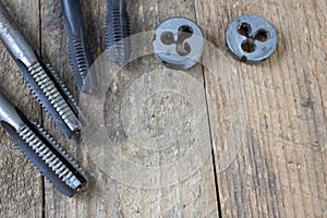 Metalwork tools on the workshop table. Threading dies and taps i