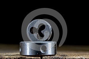 Metalwork tools on the workshop table. Threading dies and taps i