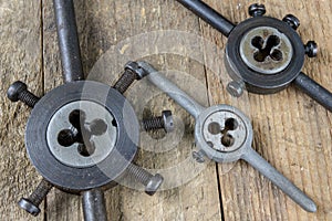 Metalwork tools on the workshop table. Threading dies and taps i