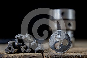Metalwork tools on the workshop table. Threading dies and taps i