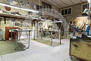 Metalwork workshop place with tools and tables, factory