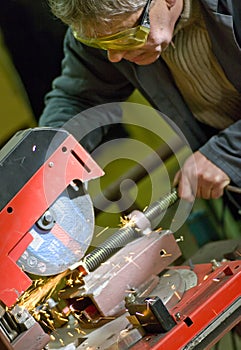 Metalworker cutting metal