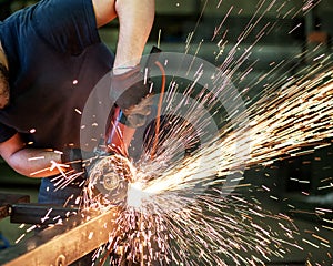 Metalworker cutting a steel bar photo