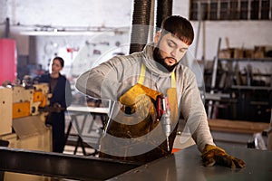 Metalworker drilling steel structures with cordless drill