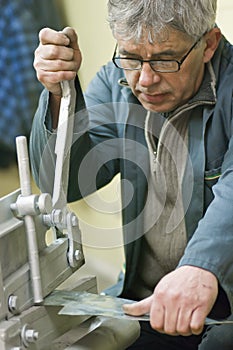 Metalworker and guillotine