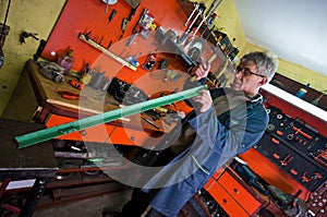 Metalworker in his garage, checking tools