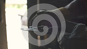 Metalworker measuring a metal part with a caliper