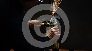 Metalworker at work with his grinder