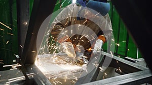 Metalworker working with angle grinder