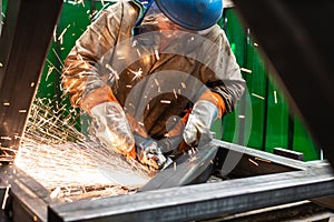 Metalworker working with angle grinder
