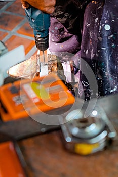 Metalworker working on a drilling machine