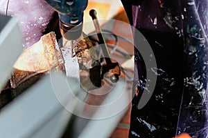 Metalworker working on a drilling machine