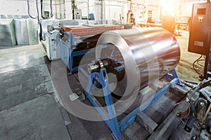 Metalworking factory. Roll of galvanized steel sheet for manufacturing metal pipes and tubes in the factory