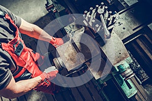 Metal Worker Processing Material Using Lathe