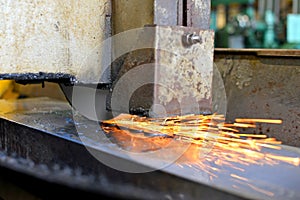Metalworking industry: finishing metal working on horizontal surface grinder machine with flying sparks