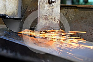 Metalworking industry: finishing metal working on horizontal surface grinder machine with flying sparks