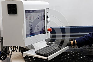 Metalworking machine operator at the control panel