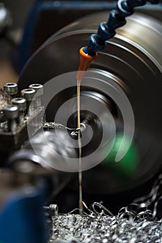 Metalworking. Small lathe machine working a piece of metal.