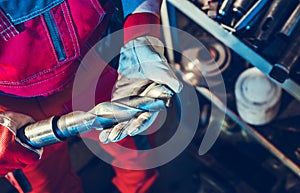 Metalworking Technician with Large Drill Bit in His Hands