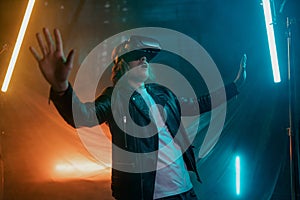 Metaverse digital cyber world technology, man with virtual reality VR goggles playing augmented reality game, futuristic