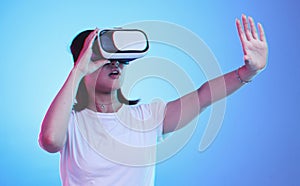 Metaverse, headset and a woman on a blue background, touching for experience and VR gaming. Virtual reality, digital and