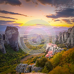 Meteora, Greece at romantic sundown time with real sun and sunset sky. Meteora - incredible sandstone rock formations. The