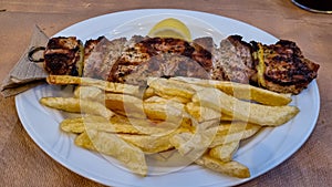 Meteora -  Greek souvlaki served in traditional restaurant in Meteora, Greece. Meat on skewers