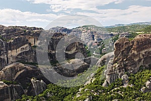 Meteora Monasteries Greece , valley and monasteries surrounded by dark cliffs