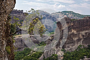 Meteora Monasteries Greece , valley and monasteries surrounded by dark cliffs