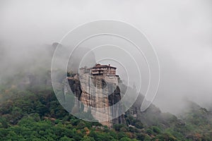 Meteora - Panoramic view on foggy day of Holy Orthodox Monastery of Rousanou (St. Barbara), Kalambaka, Meteora, Greece.